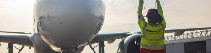 airport worker signaling in an airplane