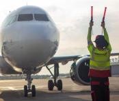 airport worker signaling in an airplane