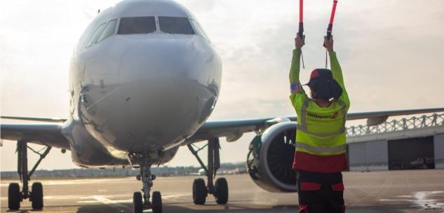 airport worker signaling in an airplane