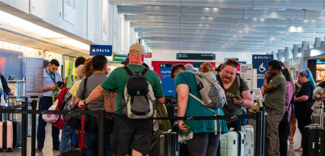 people in line checking into their flights