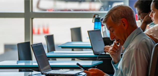 man on his phone in the food court