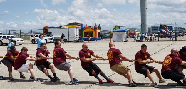 people pulling a rope for the cleveland plane pull